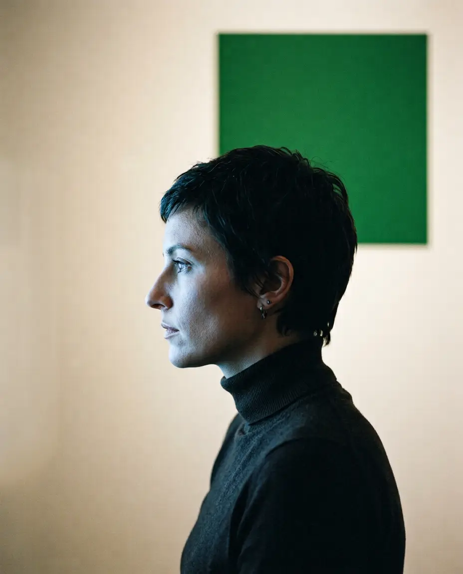 Ritratto di profilo davanti a una parete chiara con un quadrato verde